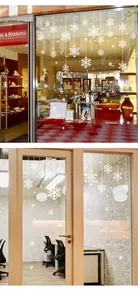 Detail of white snowflake window clings with Merry Christmas text for holiday glass decor