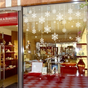 White snowflake window stickers and Merry Christmas decals for holiday storefront decor