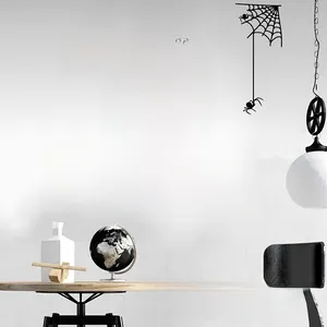 Detail of Halloween wall stickers featuring black cat, pumpkin, and bat on white wall