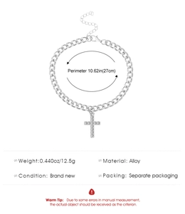 Detailed view of silver alloy cuban link chain with rhinestone cross pendant and lobster clasp