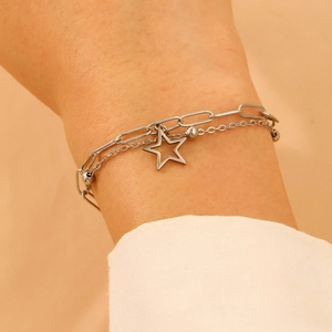 Detail of silver double-layered bracelet with paperclip chain and star charm