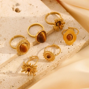 Detailed collection of vintage gold stainless steel rings with tiger eye stones