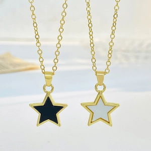 Elegant gold necklaces featuring black and white enamel star pendants for women