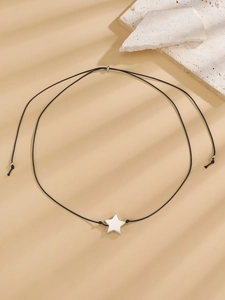 Minimalist black cord necklace with a polished silver star pendant and bead detail