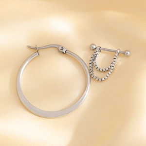 Punk style silver hoop earrings and barbell chain studs set on luxury silk background