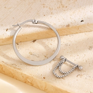 Silver punk style hoop earring and box chain barbell earring set on stone display