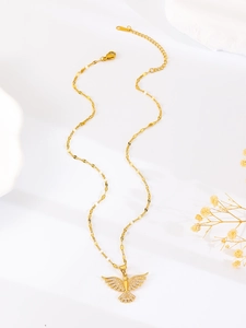 Detail of gold eagle pendant with zircon pavé setting on a stylish flat link chain