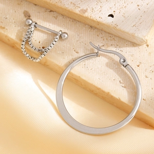 Close-up of minimalist silver paperclip earring set with chain details on stone background