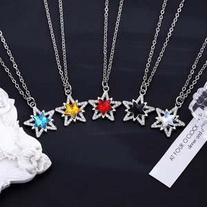 Macro detail of five pointed star pendants with colorful cubic zirconia and micro-pave crystals