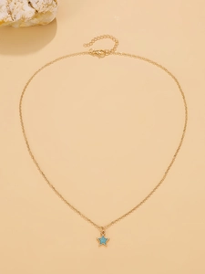 Detailed shot of gold necklace featuring blue star pendant with glitter effect and lobster clasp