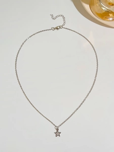 Close-up of a silver star pendant necklace with white inlay on an O-chain link