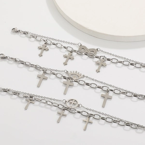 Detail of silver double-layered chains with cross and infinity pendants for men and women