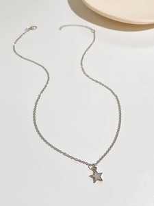 Detailed view of silver star necklace with mother-of-pearl inlay and lobster clasp