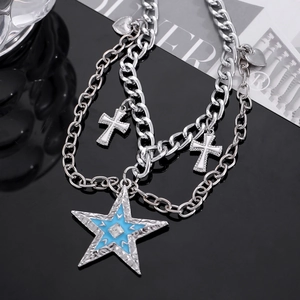 Close-up of silver chain necklace with blue star pendant and cross charms on black background