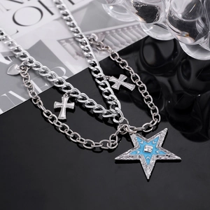 Close-up of multilayered silver star necklace with blue enamel and crystal details