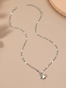 Detail view of silver star necklace featuring fine chain and adjustable lobster clasp