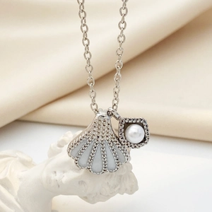 Elegant silver mermaid shell pearl pendant necklace with zircon crystals on satin fabric