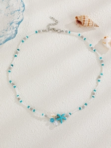 Detailed shot of ocean theme necklace with shell, starfish pendant and pearl beads