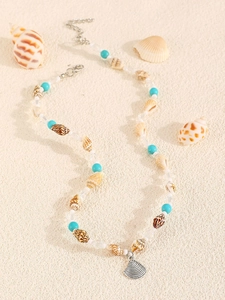 Macro detail of a beaded ocean necklace with shell charms and turquoise beads