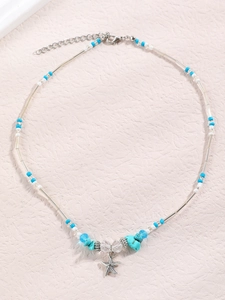 Detail of bohemian starfish pendant necklace with blue beads and silver elements