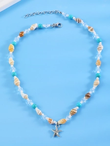 Detailed close-up of shell necklace with blue beads and silver starfish pendant