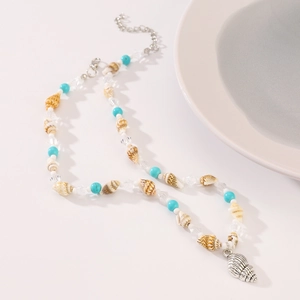 Close-up of bohemian shell necklace with turquoise beads and silver conch shell pendant