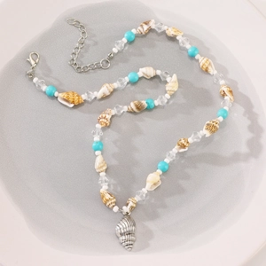 Detail of bohemian shell necklace with turquoise beads and silver conch pendant