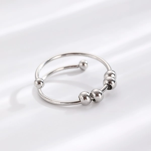 Polished silver fidget ring featuring four movable rainbow beads on a spiral band