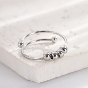 Close-up of rotatable silver beads on a double-layer spiral anti-stress ring for women