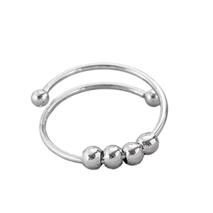 Close-up of rotatable silver spinner ring with four polished beads for stress relief