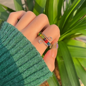 Adjustable silver spinner ring with colorful beads for anxiety relief on a hand