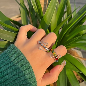 Detail view of rotating anxiety rings with silver and rainbow beads on hand