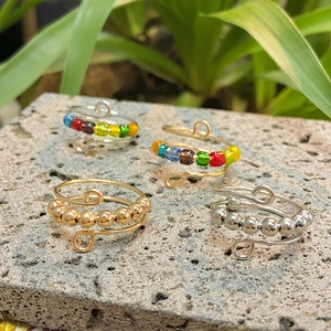 Adjustable rainbow bead anxiety rings set in gold and silver finish for stress relief