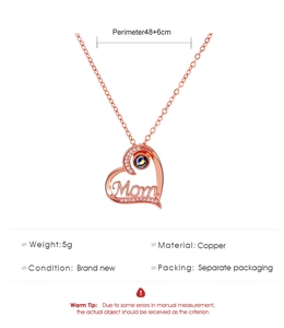 Detail view of rose gold heart pendant with Mom lettering and projection stone specs