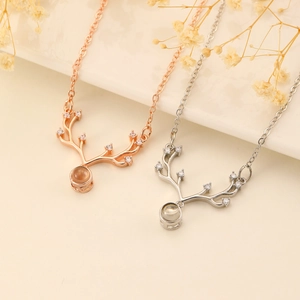 Rose gold and silver elk antler necklaces with 100 languages projection stone