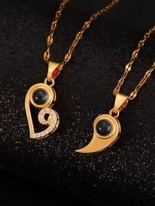 Macro detail of sun and moon couple necklaces with gold plating and projection stone
