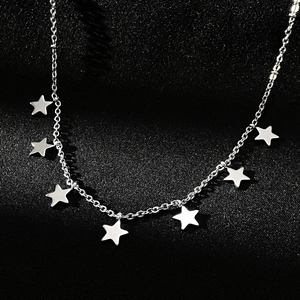 Detail shot of silver star charms on minimalist stainless steel y-necklace chain