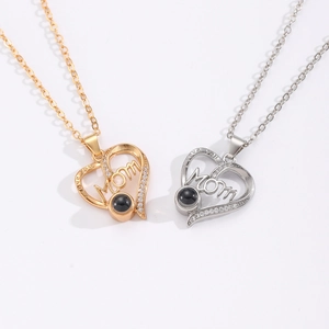 Close-up of heart-shaped MOM necklace featuring a projection stone and diamond inlay