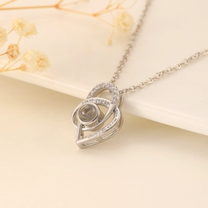Silver projection necklace with interlocking double hearts and sparkling cubic zirconia stones