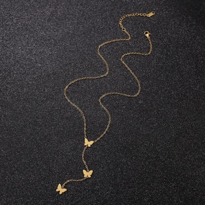 Macro view of gold butterfly Y-pendant necklace with S.STEEL hallmark detail