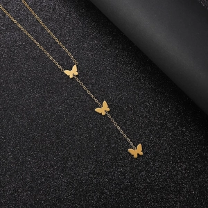 Close-up of golden stainless steel Y-shaped necklace with three butterfly pendants