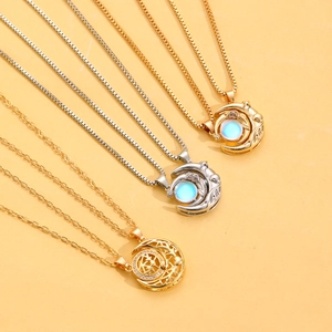 Detail view of magnetic sun moon necklaces with glowing opal beads and gold plating