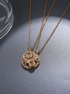 Detail of magnetic sun and moon couple necklaces with projection stones in gold finish