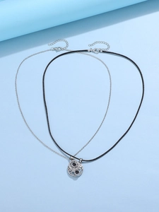 Detail of sun and moon magnetic necklaces with projection stones on blue background