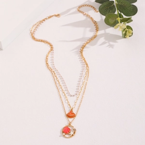 Detail of layered gold necklace featuring summer ocean charms shell and starfish
