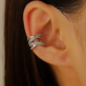 Detailed close-up of a silver multi-layer ear cuff with sparkling zircon accents