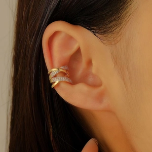 Close-up of gold-plated multi-layer ear cuff with shimmering zircon stone inlay