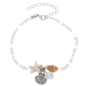 Bohemian beach anklet with starfish shell charms and white beads on a white background