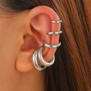 Detail of 5-piece silver metal ear cuff set on model ear for non-pierced ears