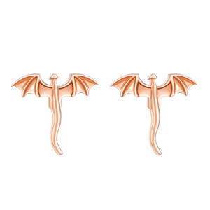 Close-up of rose gold dragon stud earrings with detailed wings and polished finish
